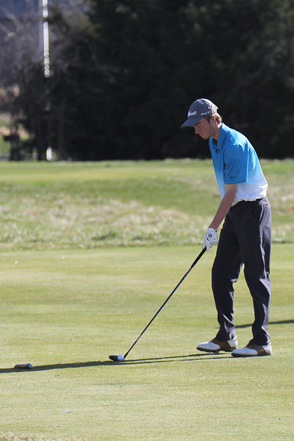 Senior Matthew Bahle puts his ball.