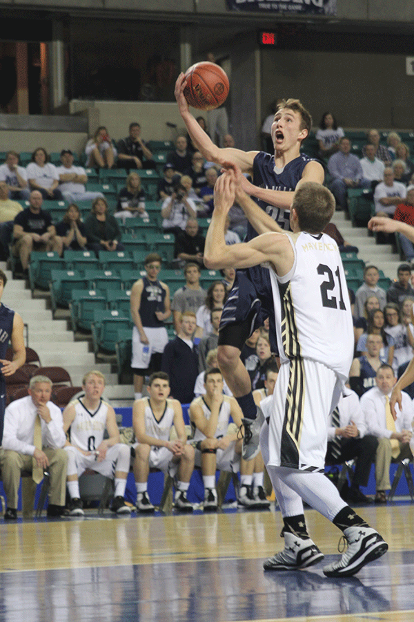 Determination on his face, junior Jaison Widmer goes up for a shot against Mazie South.