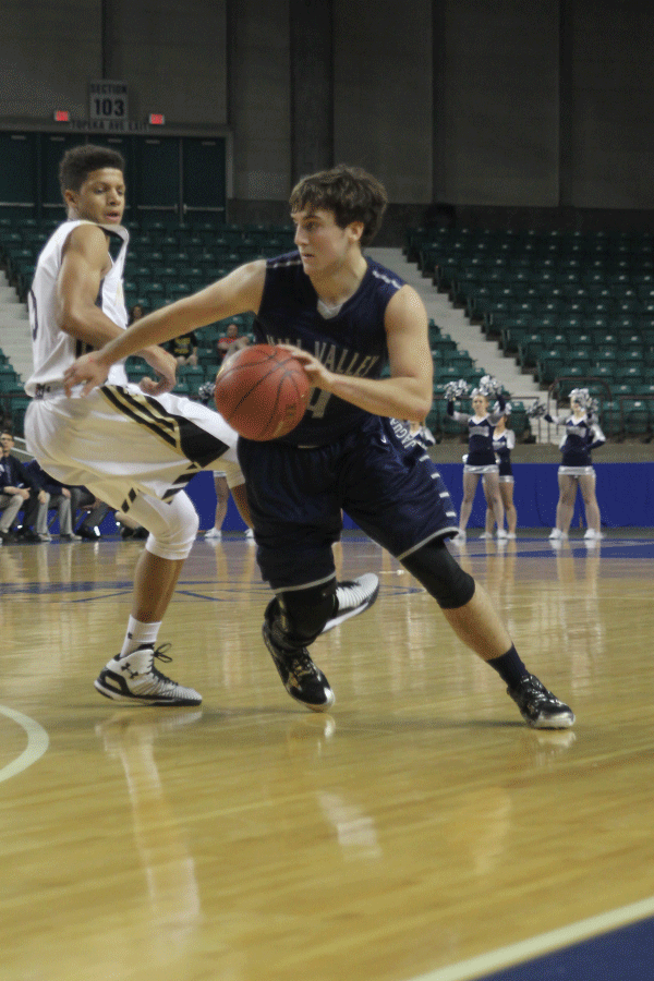 Driving past a Mazie South opponent, junior Logan Koch dribbles the ball.