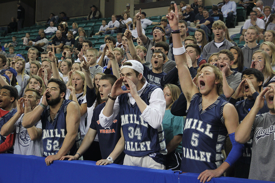 Many students, including junior Lucas Krull, yell in support of the boys basketball team.