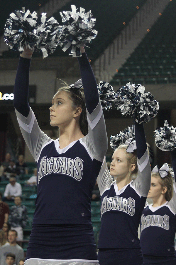 With her pom-poms in the air, sophomore Taylor Weber anticipates a free throw. 