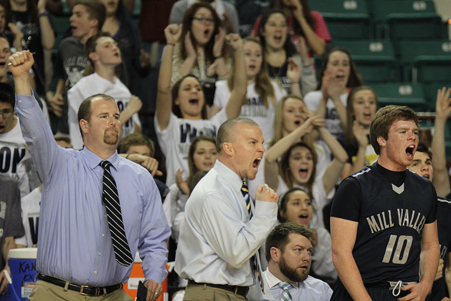 Head coach Mike Bennett cheers after a basket is made. 