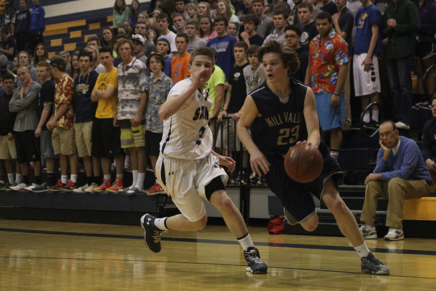 Freshman Cooper Kaifes avoids Aquinas defense.