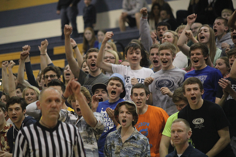 Students get pumped up after a foul is called when junior Jaison Widmer shoots a layup. 