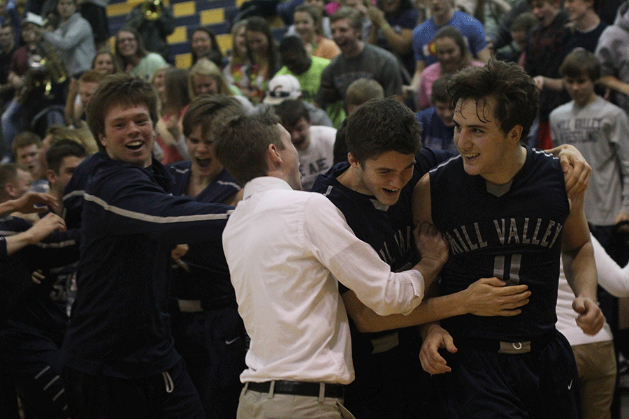 Junior Logan Koch smiles with him teammates after making the shot that won them the sub-state championship