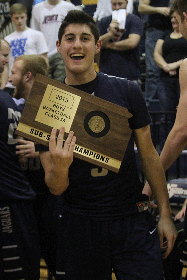 Senior Evan Kopatich poses with the sub-state championship trophy. 