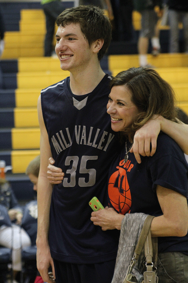 Junior Clayton Holmberg and his mother pose for a photo.