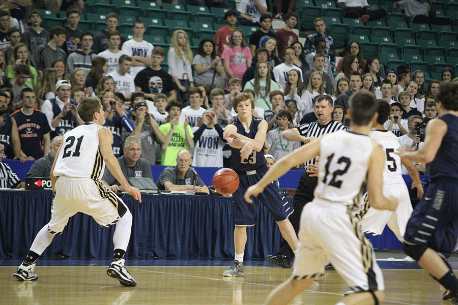 The student section cheers while freshman Cooper Kaifes passes to an open player.