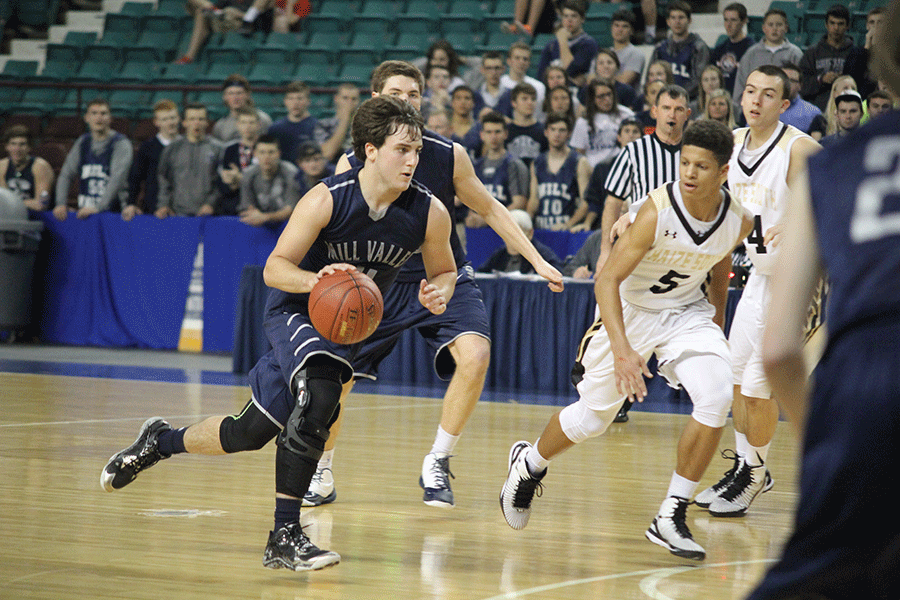 Junior Logan Koch dribbles the ball to the basket.