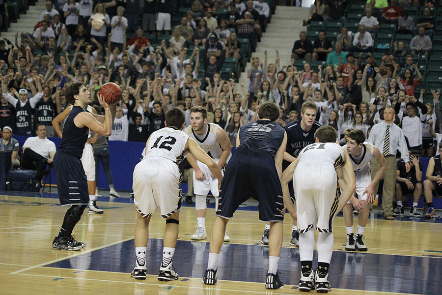 While junior Logan Koch shoots a free throw, the student section cheers him on.