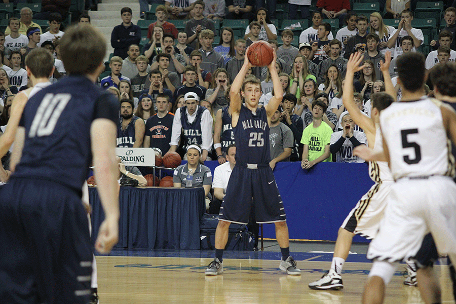 Looking for an open teammate, junior Jaison Widmer holds the ball.