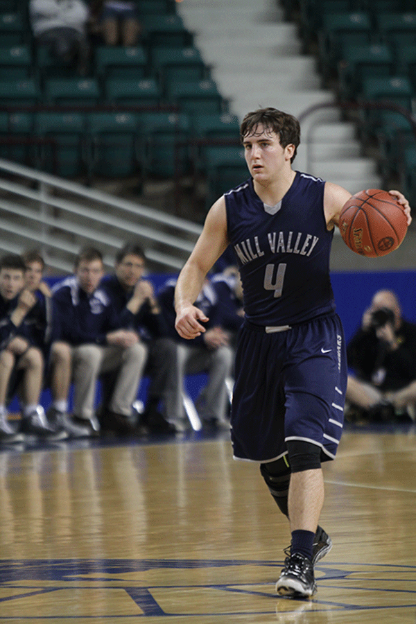 Junior Logan Koch brings the ball downcourt.