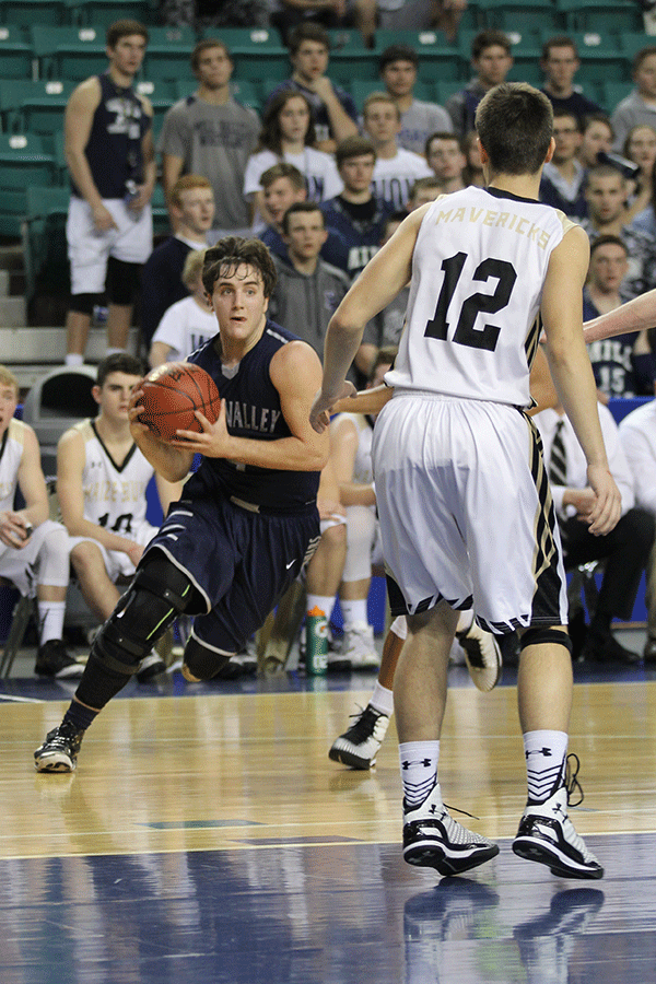 Junior Logan Koch drives to the basket in the first half of play.
