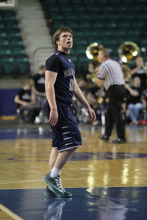 After the game, senior Conner Kaifes looks at the scoreboard while walking off the court.