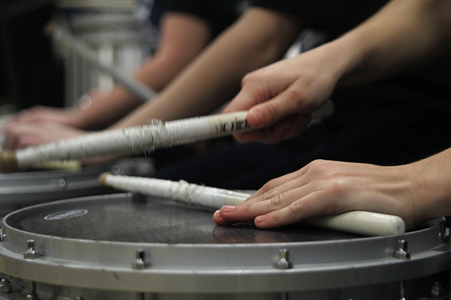 Senior Val Stuerman plays the snare drum at the boys basketball game on Thursday, March 5.