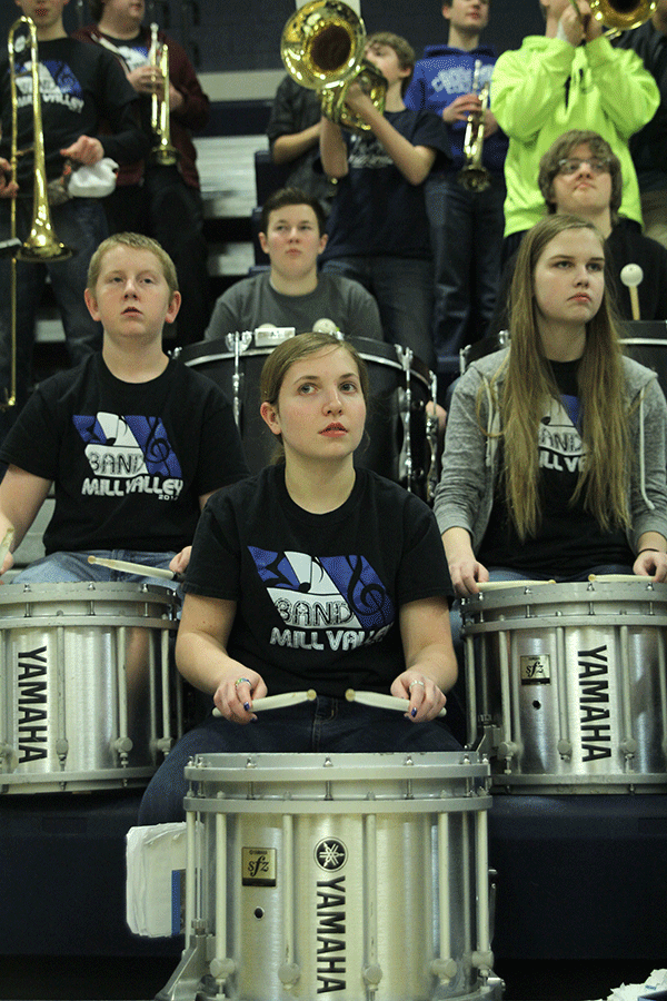 Pep band percussion members ready themselves for a song that will be played during a timeout on Thursday, March 5.