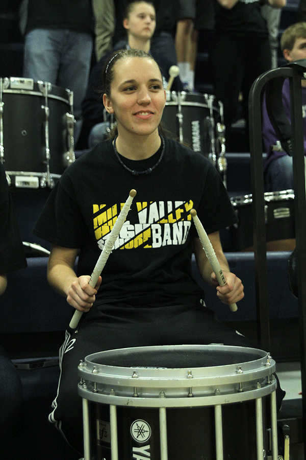 During a timeout at the boys basketball game on Thursday, March 5, senior Val Stuerman provides a beat for the pep band to follow. “I just like hanging out with all of the guys and being able to play music with them,” Stuerman said.