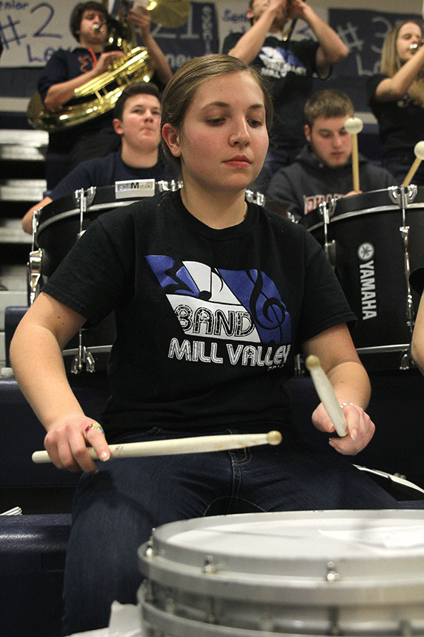 Freshman Hope Sulzman looks down at her sheet music while playing the snare drum on Friday, February 27. 