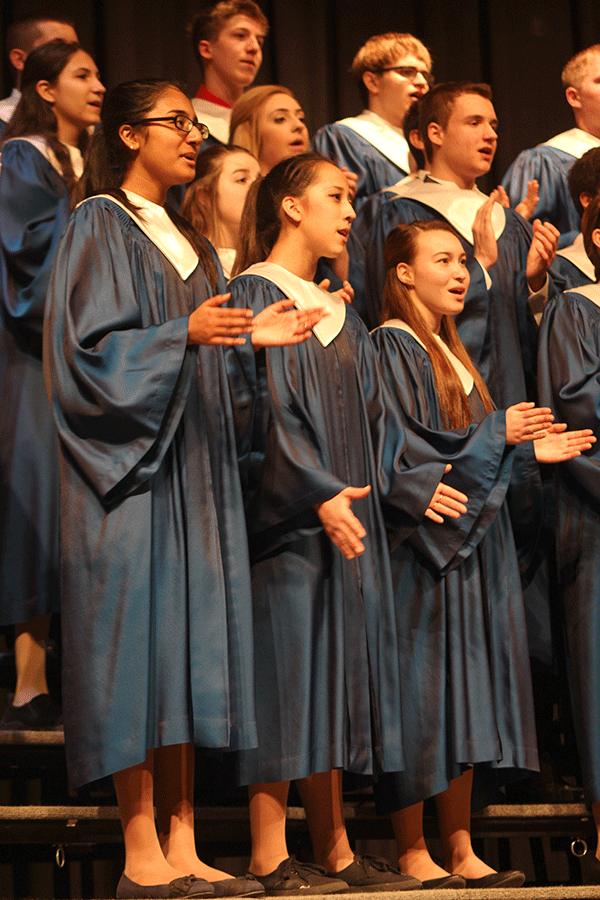 The Freshman Girls and Boys Mixed Choir clap to the beat of their song.