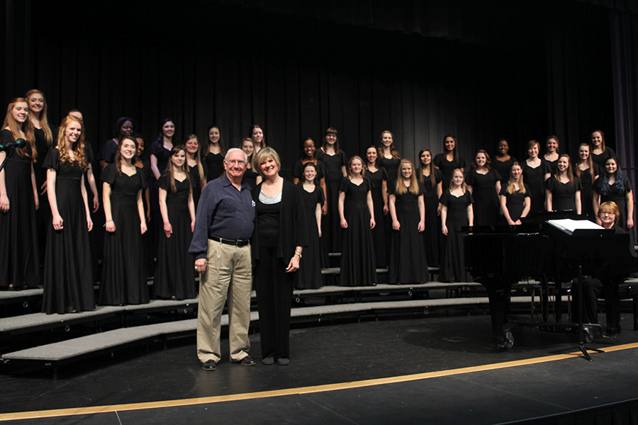 The choir teacher Sherree Stoppel stands with composer Eugene Butler and The Treble Ladies.