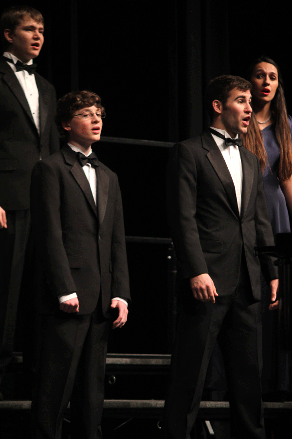 Junior Allen Winert and Senior Eli Stewart sing during the choir concert.
