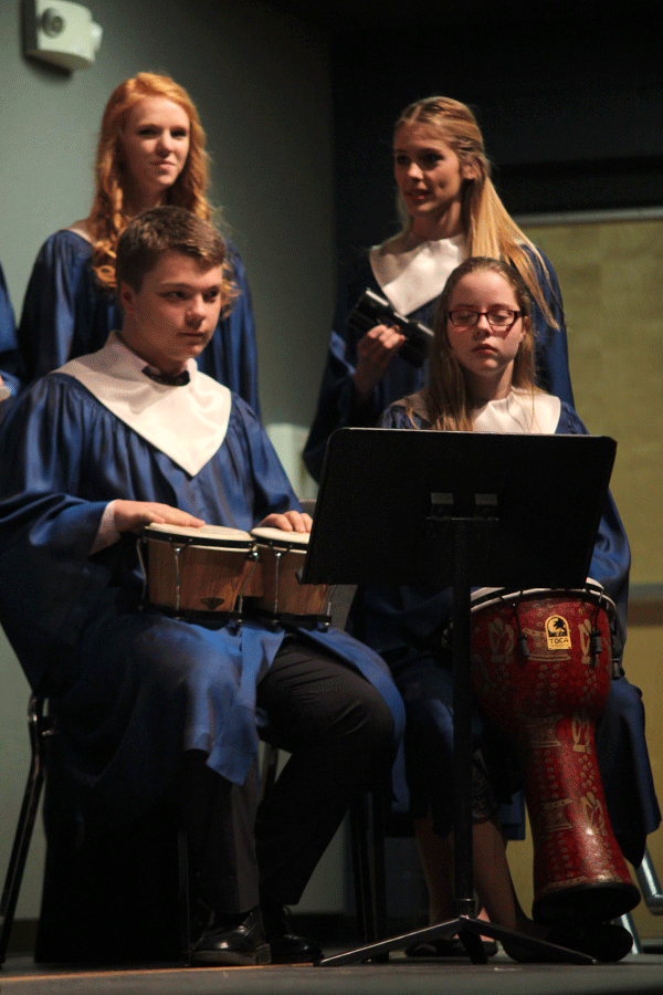 Students from the Freshman Boys and Girls Mixed Choir play background instruments during the choir concert.