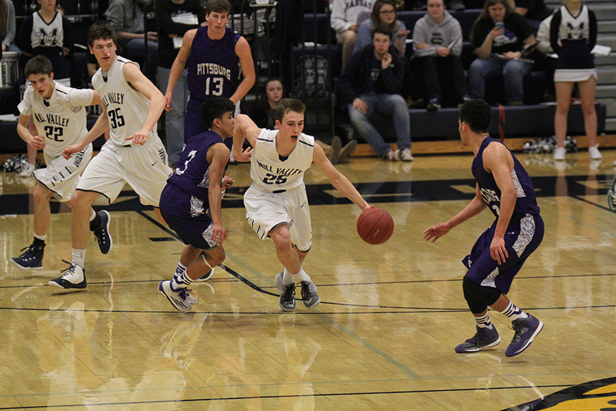 Junior Jason Widmer runs between two Pittsburg defenders.