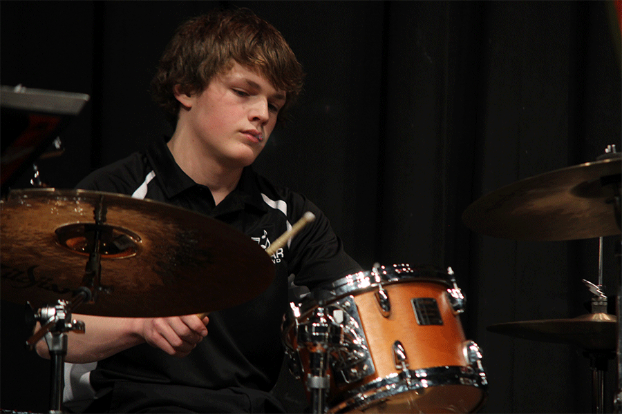 Drum sticks in hand, sophomore Spencer Smith concentrates on playing the drums.