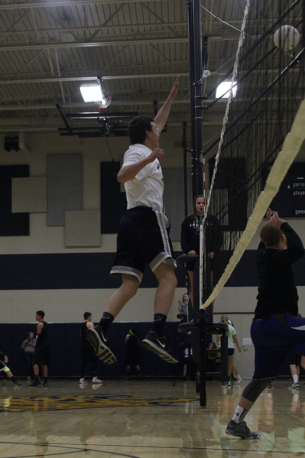 Junior Nick Lecuru jumps in the air to block the ball on Wednesday, March 25. 