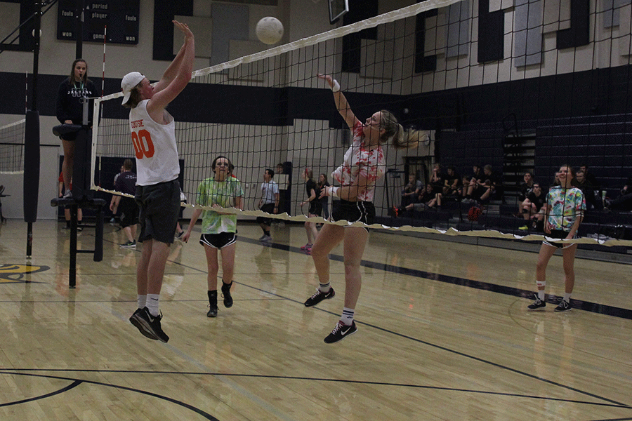 Junior Greyson McDonald jumps to block freshman Izzy Hellons hit on Wednesday, March 25. 