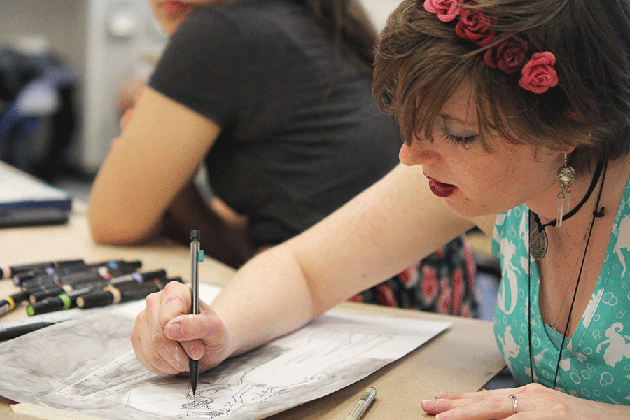 Working on her concentration piece in her AP Studio Art class on Monday, March 30, senior Aislynn Quinn sketches the base for her design.