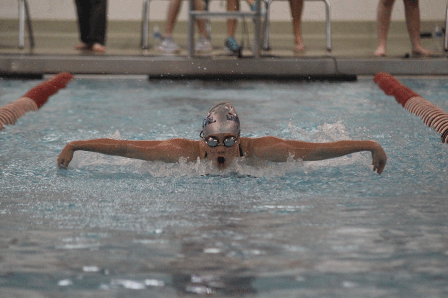 Freshman Vignuelle Puliatti competes in the butterfly stroke. 