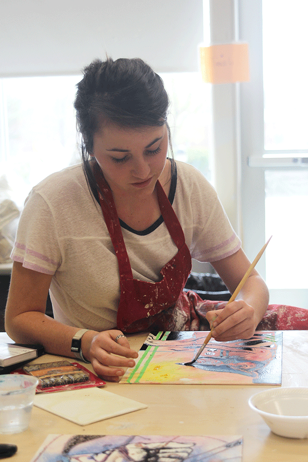 In her silver 4 AP Studio Art class, senior Taylor Felshaw adds India ink to her improvisational piece on Wednesday, April 1. 