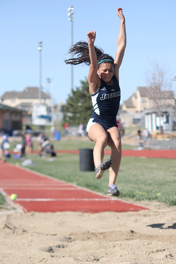 Junior Taylor Corbitt prepares to land in long jump. 