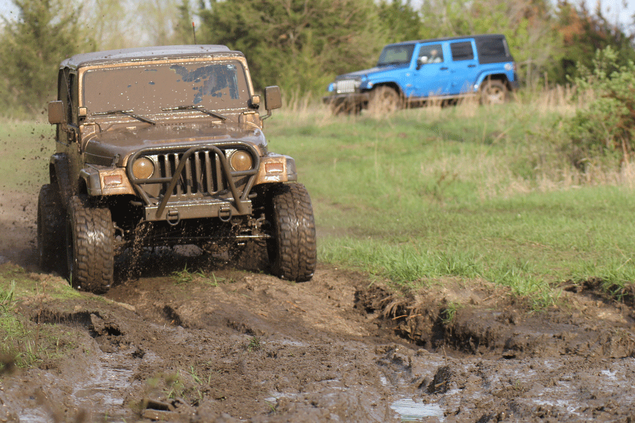 In his 2000 Jeep Wrangler Sport, junior Cole Griggs leads junior Katie Burke through a track of mud. 