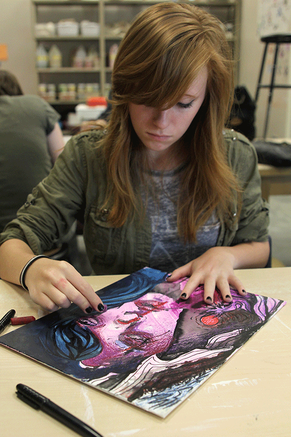 Sophomore Sophie Griffin adds soft pastel to her art piece on Friday, April 3. 