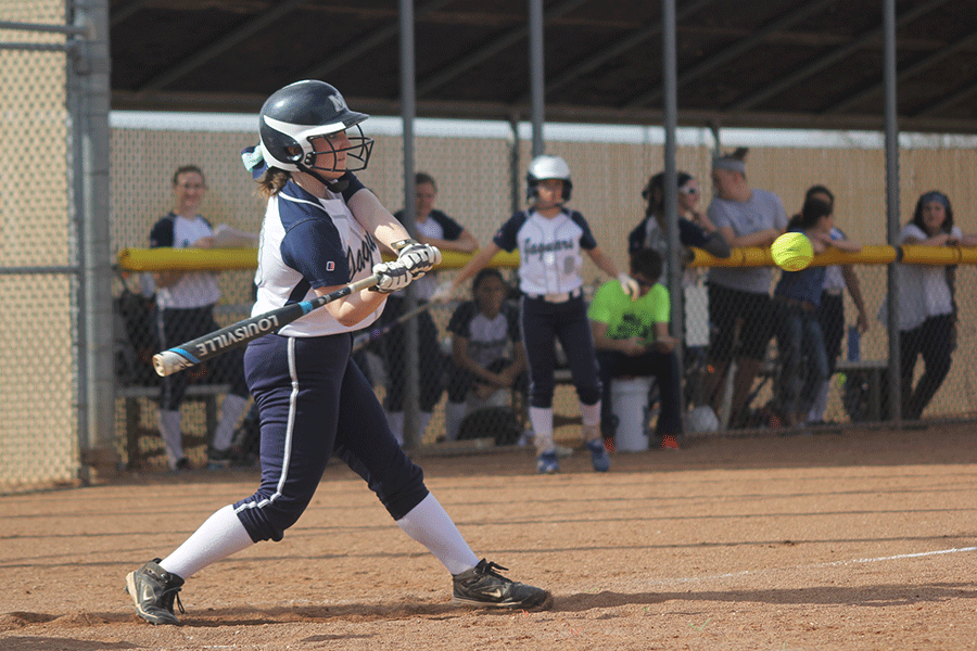 Senior Kaitlyn Jackman swing at the softball.