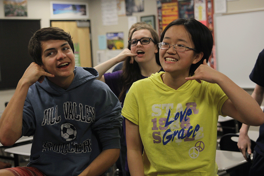 While having some free time, junior T-Ying Lin and  senior Grant Gustafson play charades with other members of the Forensics team.