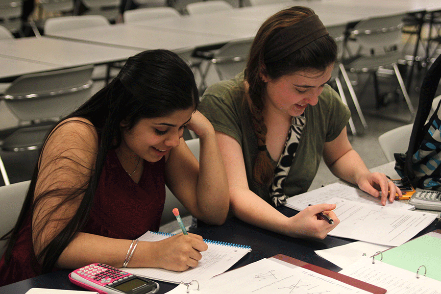 Preparing for the math competition, sophomores Harman Kaur and Madison Ferguson work out some practice problems on Wednesday, April 1.