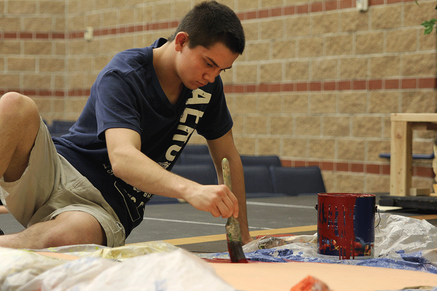 Painting an intermission sign, senior Austin Markovich works diligently during Stagecraft class on Thursday, April 16 to complete the final touches of the set for the Triple One-Act Stravaganza. Students will perform the first act of three different plays on show nights running Tuesday, April 28 through Friday, May 1. 