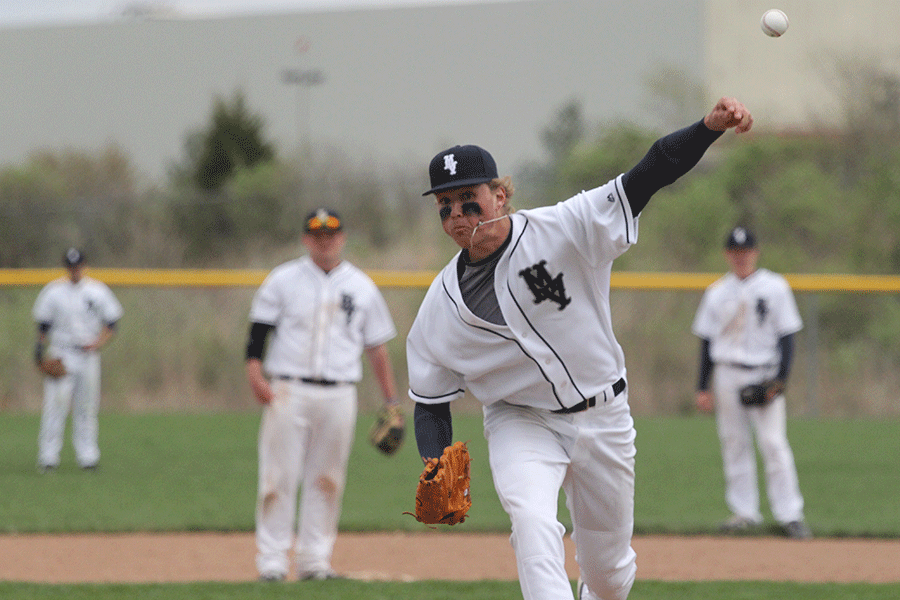 Before taking the mound, junior Lucas Krull warms up by throwing a few pitches on Thursday, April 9. “I love [pitching],” Krull said. “It’s what I’m going to college for and hopefully after that I can keep going for my career.” 