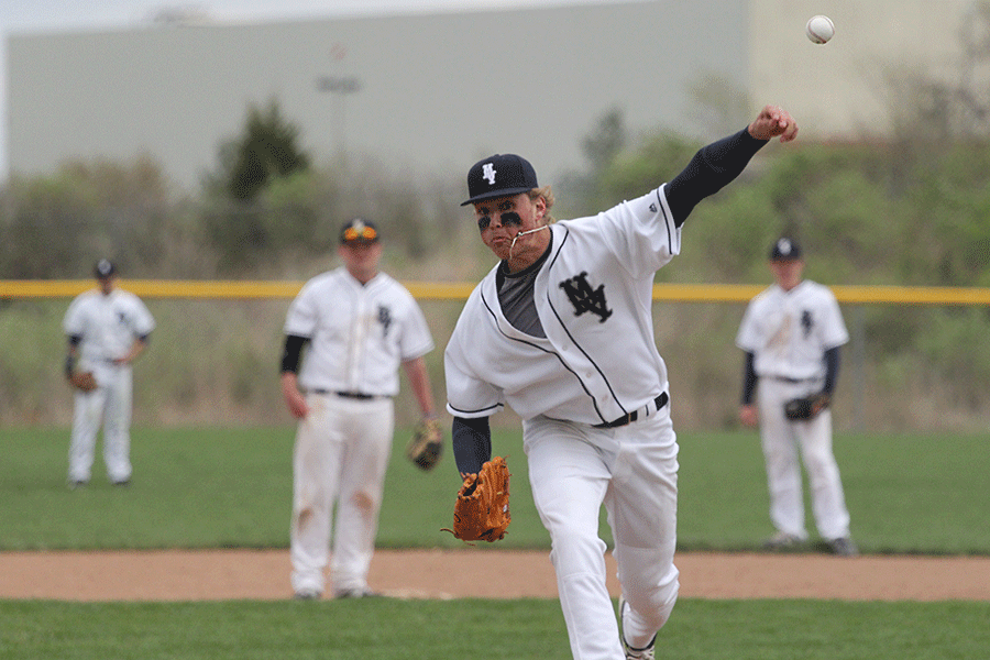 Preparing for the next inning, junior Lucas Krull throws a few pitches to warm up. The Jaguars defeated the Basehor-Linwood Bobcats in a double header with scores of 16-0 and 19-9 on Thursday, April 9.