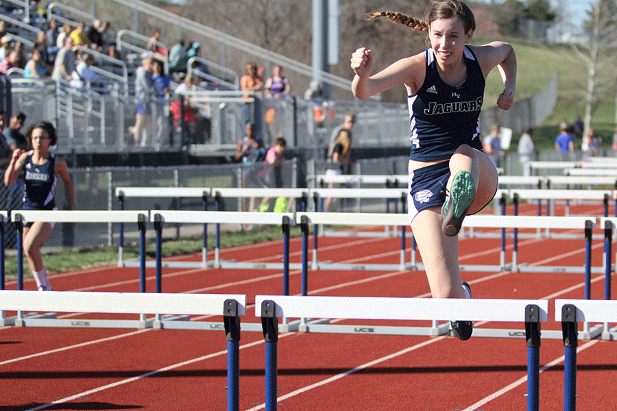 Jumping over a hurdle, junior Merrick Vinke pushes to finish her race.