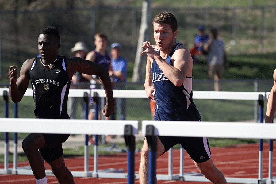 Senior Cody Deas sprints to the next hurdle.