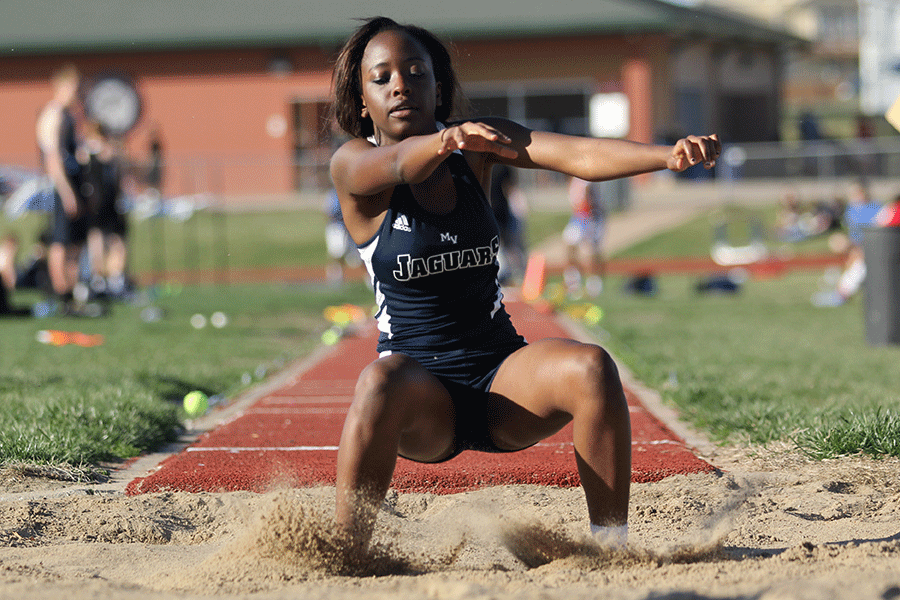 Landing in the sand, sophomore Nicole Lozenja finishes her triple jump.