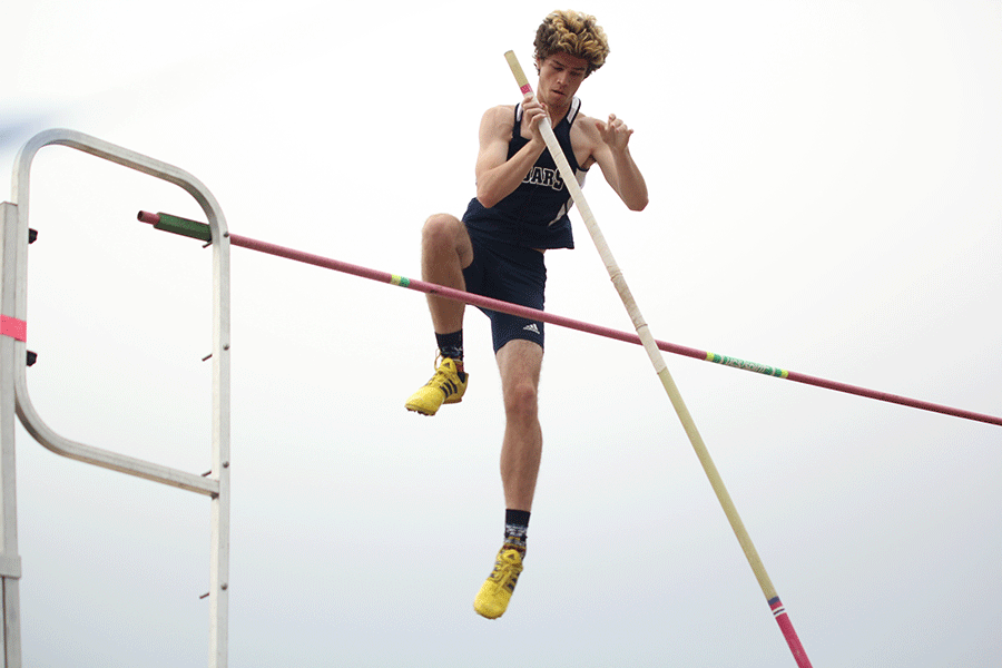 After making it over the vault, junior Cooper Hutteger pushes back his pole.