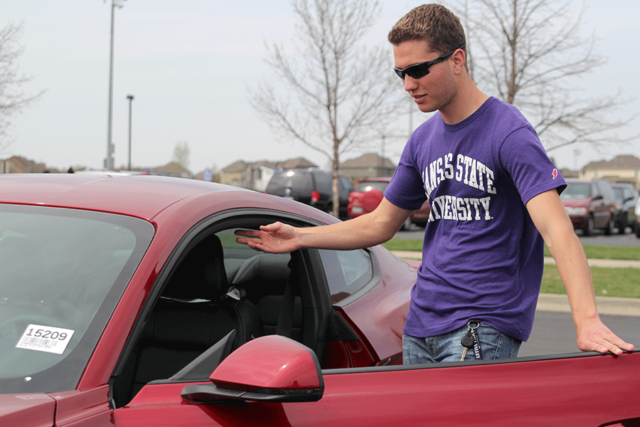 Senior Cody Deas gets into a 2015 Ford Mustang during the Drive 4 UR School event on Saturday, April 11.