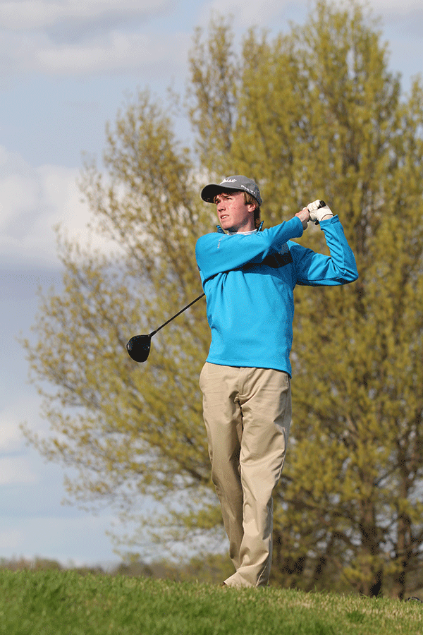Senior Matt Bahle follows through with his swing at the boys golf meet on Monday, April 20.