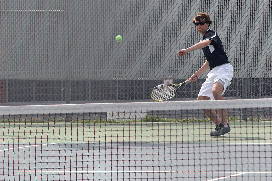 During the all day tennis  tournament, sophomore Aaron Middaugh returns a serve. 
