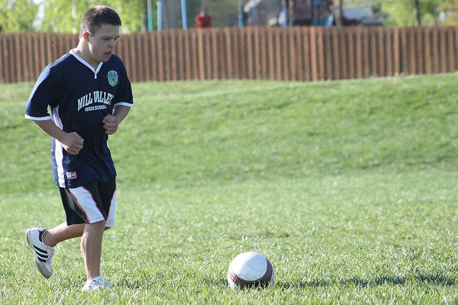 Preparing to kick the ball during a drill, Matthew Santaularia practices with the unified soccer team on Sunday, April 26. 